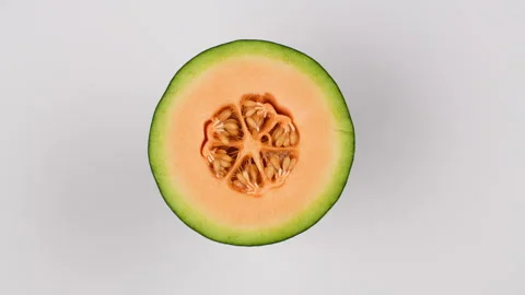 Rotating Close Up Half Green Netted Melon With Orange Flesh And Seeds 4K Stock Footage 323018252
