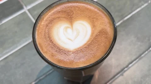 Rotating Close-Up of Latte Coffee with Heart-Shaped Latte Art Stock Footage 332087278
