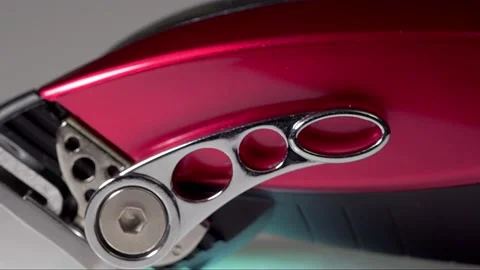 A rotating close up macro clip of barbers red professional quality hair clipp Video stock 149063793