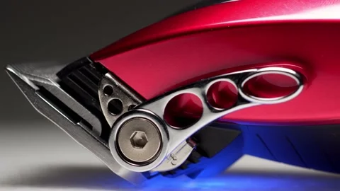 A rotating close up macro clip of barbers red professional quality hair clippers Vídeo Stock 149590340