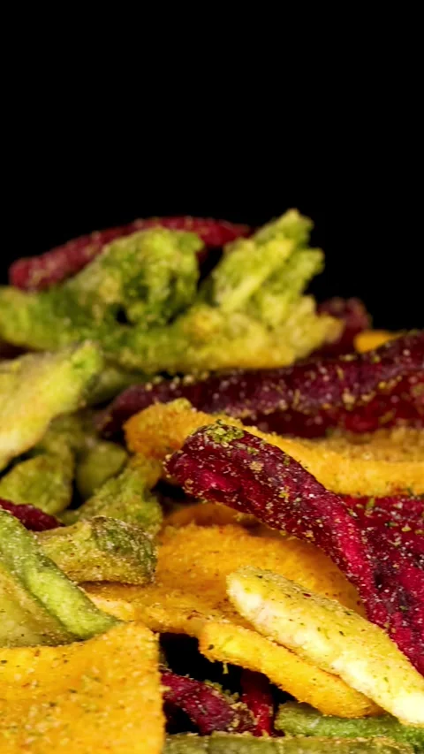 Rotating Close-Up of Mixed Vegetable Chips Against Black Background Stock Footage 321736041