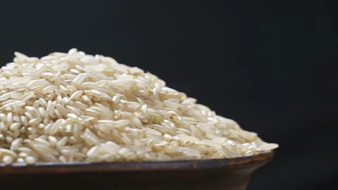 Rotating close up of a pile of raw rice Stock Footage 98983171