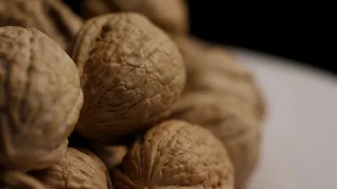 Rotating close up shot of walnuts in a pile Stock Footage 327910863