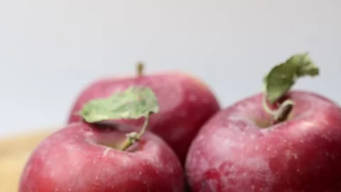 Rotating close-up of three fresh red apples with a smooth surface. Stock Footage 299051574