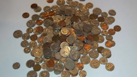 A rotating close up of U.S coins 스톡 동영상 105724775