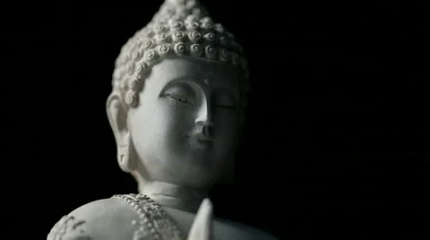 Rotating closeup of Buddha head against isolated black background (loop) Stock Footage 65523895