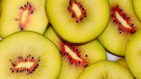 Rotating closeup view of vibrant red kiwi slices showcasing bright yellow f.. Stock Footage 321832768