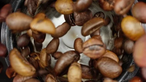 Rotating coffee beans in coffee grinder. Grinding roasted coffee beans. Stock Footage 279448920