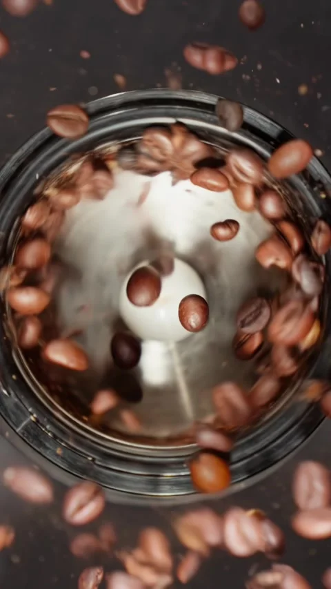 Rotating coffee beans in coffee grinder. Grinding roasted coffee beans. Stock Footage 297610055