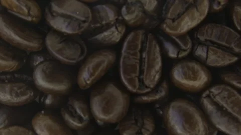 Rotating Coffee Beans With Light Smoke Macro. Видео 334575227