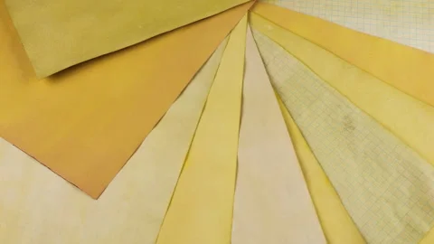 Rotating collection of handmade paper sheets showcasing a variety of yellow. Stock Footage 330253105