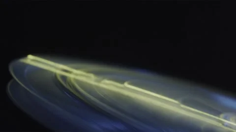 Rotating colored disk on a dark background Stock Footage 252383261