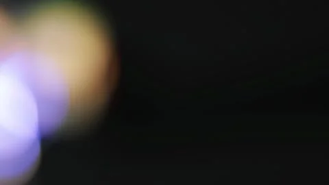 Rotating colorful bokeh with bright light rays on black for digital screens.. 스톡 동영상 341736899