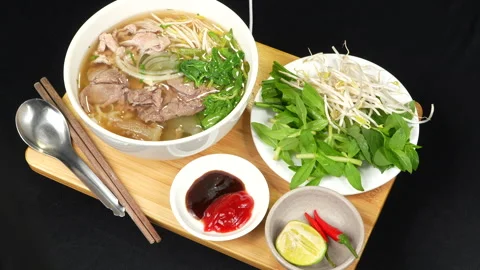 Rotating Complete Vietnamese Pho Combo Set with Herbs and Sauces Video stock 339658712