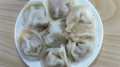 Rotating cooked dumplings on a plate close-up Stock Footage 141545461
