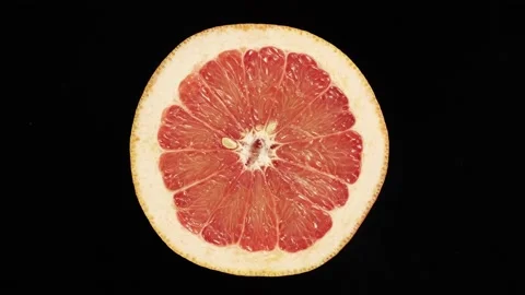 Rotating In A Cross Section Grapefruit On A Black Background. Video stock 234547168