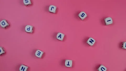 Rotating cubes or blocks word with letters randomly on a pink background - the Stock Footage 197152297