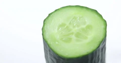 Rotating cucumber on a white background, a slice of green fresh cucumber. Stock Footage 145446352