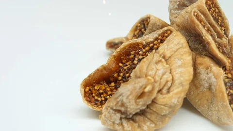 Rotating cuts dried Figs on white background in right side Stock Footage 82642975