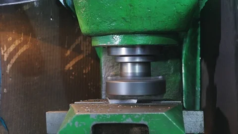Rotating cylinder peeling flakes from a lying metallic stripe with sparkles Stock-Footage 100267920