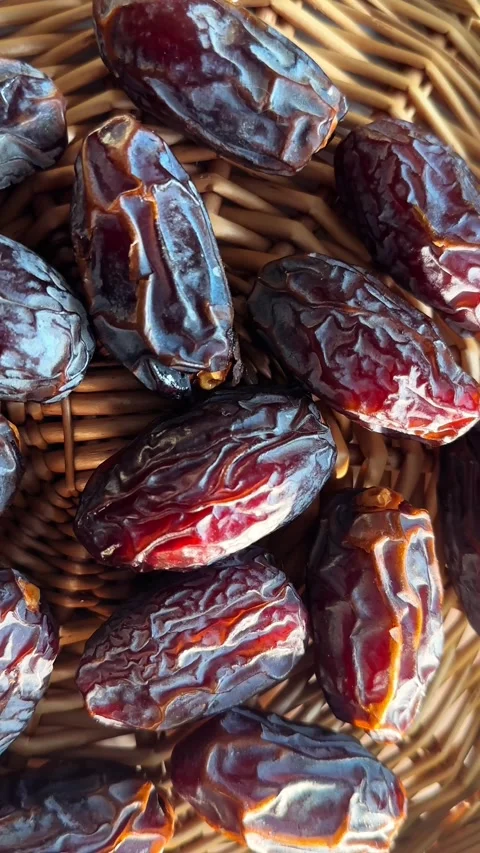 Rotating date fruit in wicker basket close up with wrinkled glossy skin and.. Stock Footage 339266774