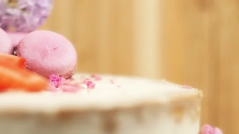 Rotating decoration of handmade cake with macaroons, sliced strawberries and Stock Footage 99488938