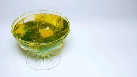 Rotating dessert gelatin multicolour on white background uhd Stock Footage 82746756