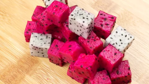 Rotating Diced Red and White Dragon Fruit Mix Cubes on Wooden Board 4K Stock Footage 320619577