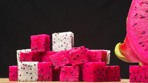 Rotating Diced Red and White Dragon Fruit Mix with Half Isolated on Black 4K Stock Footage 320623045