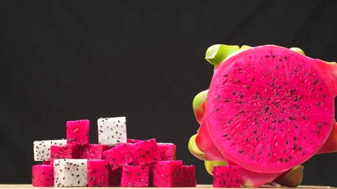Rotating Diced Red and White Dragon Fruit Mix with Half Isolated on Black 4K Stock Footage 320623861
