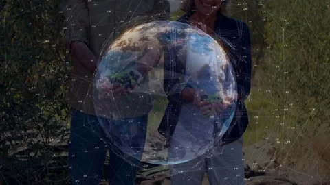 Rotating digital globe revealing faces and hands while farming pair presenting Stock Footage 332566089