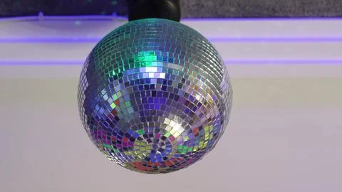 Rotating disco ball on the ceiling of the room Stock Photos