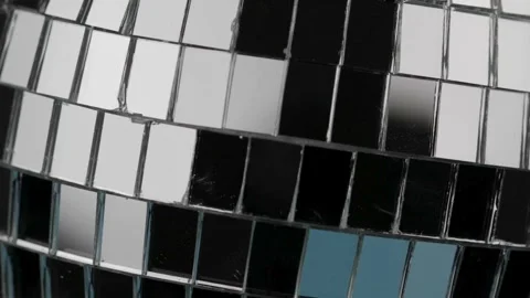 Rotating disco ball, extreme close-up. A mirrored disco ball in close-up ro.. Stock Footage 265761556