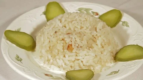 Rotating dish of rice with marinaded cucumbers Video stock 70069942