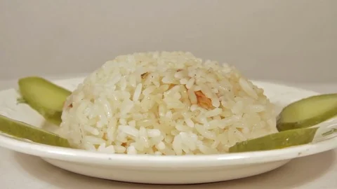 Rotating dish of rice with marinaded cucumbers Stock Footage 70070448
