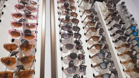 Rotating display of colorful sunglasses in optical store Stock-Footage 283757125