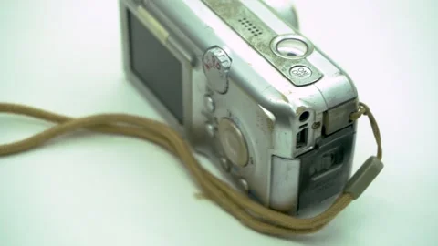 Rotating display of an old vintage digital camera on a clean white backgrou.. Stock Footage 342019462