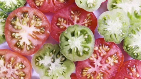 A rotating display of slices of heirloom tomatoes Stock Footage 328572010