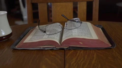 Rotating dolly shot of a Bible on a table Stock Footage 270086293
