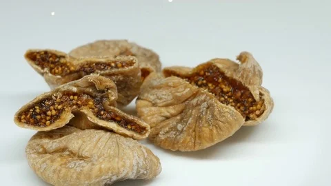 Rotating dried Figs on white background Stock Footage 82643896