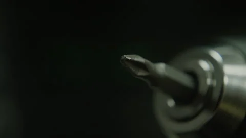 Rotating drill bit flat or cross recess head, macro extreme close-up, technol Stock Footage 220105192
