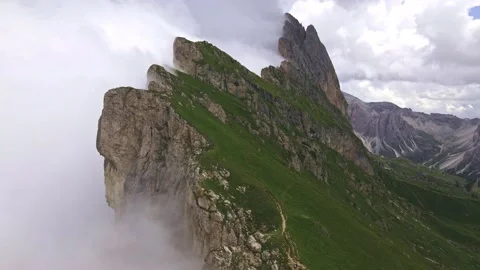 Rotating drone footage of Seceda mountain in dolomites covered in clouds. Stock Footage 224543912