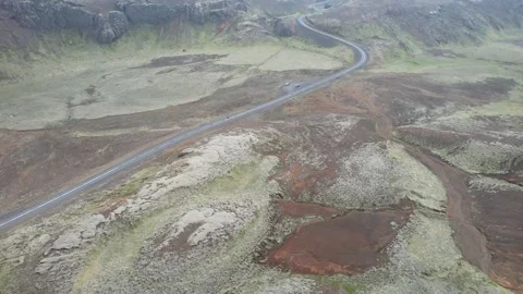 Rotating drone reveal of winding road in volcanic terrain, Nesjavellir Iceland Stock Footage 346552209