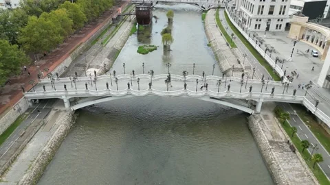 Rotating Drone Shot of a Beautiful Bridge on a River While People Walking on it Stock Footage 214312125
