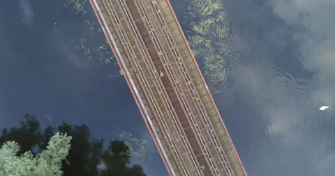 Rotating Drone shot of railway bridge over river Stock Footage 205314660