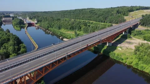 Rotating drone view of canal locks and highway bridge Stock Footage 321649966
