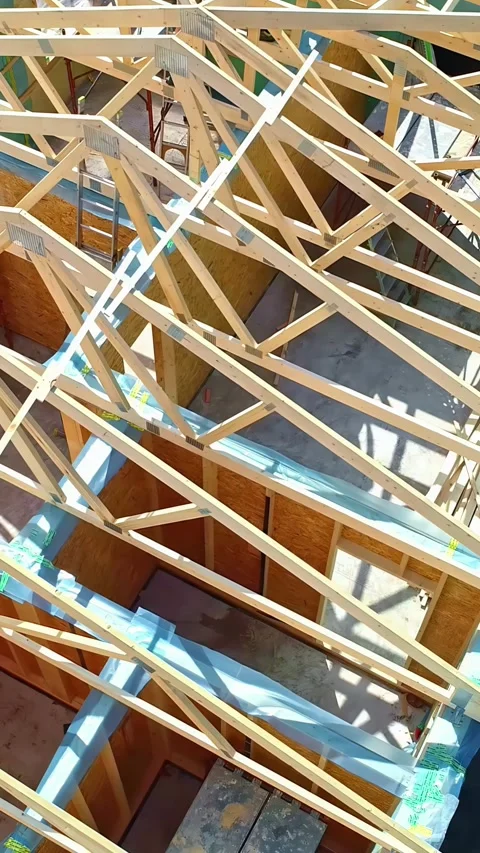 Rotating drone view of wooden framework likely of building or construction Stock Footage 303882606