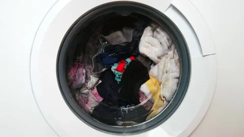 A rotating drum of a washing machine with laundry close-up Stock Footage 146761485