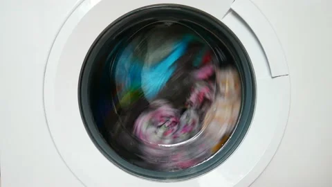 A rotating drum of a washing machine with laundry Stock Footage 146877612