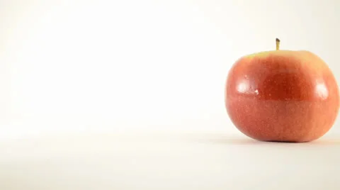 Rotating Empire Apple Against White - Dolly Left Stock Footage 24471193